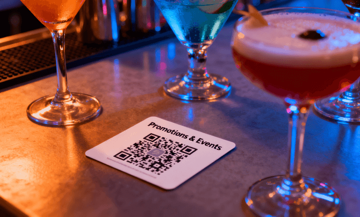QR code card displayed on a bar counter to promote restaurant offers.