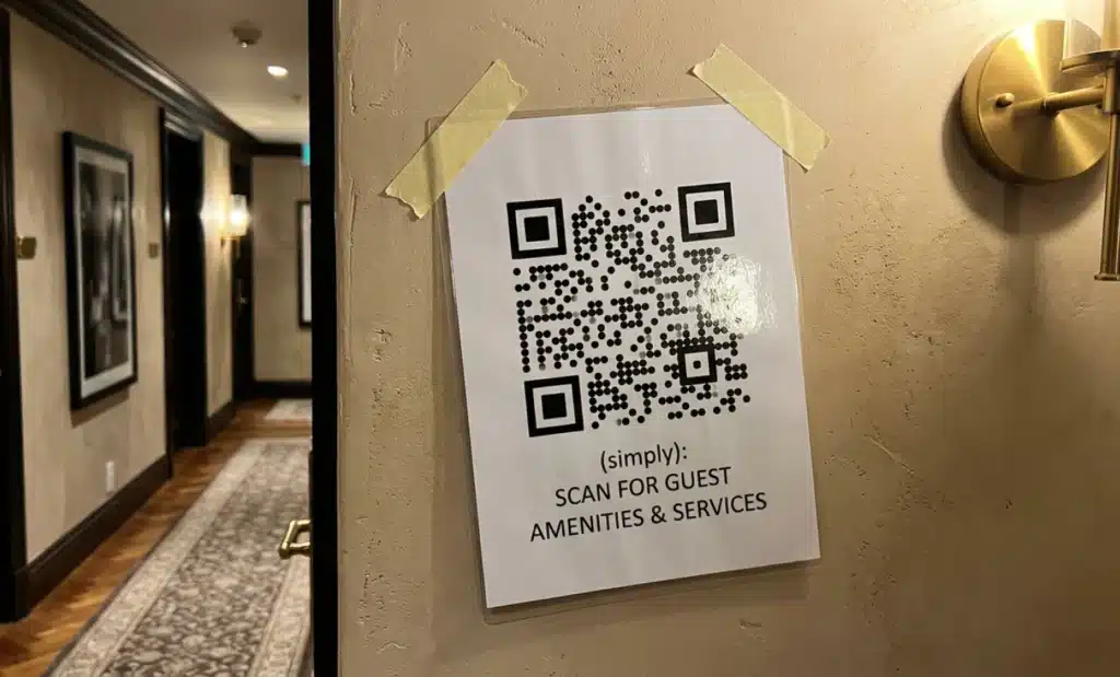 Why does every boutique hotel need a QR code for boutique hotel branding? 2 Generic laminated QR code sign clashing with an elegant boutique hotel interior